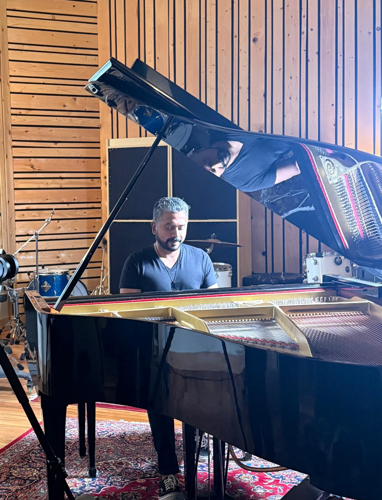 Laji George performing at the piano, showcasing his soulful rock style